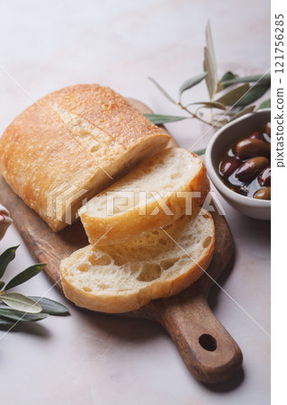 Natural kalamata olives in oil with spices and fresh ciabatta. Mediterranean food concept. 121756285