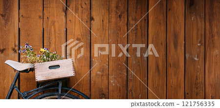 Vintage bicycle with upcycled wooden crate and potted plants against rustic wooden wall, emphasizing sustainable living and creative gardening solutions. Sustainable Lifestyle and Upcycling 121756335