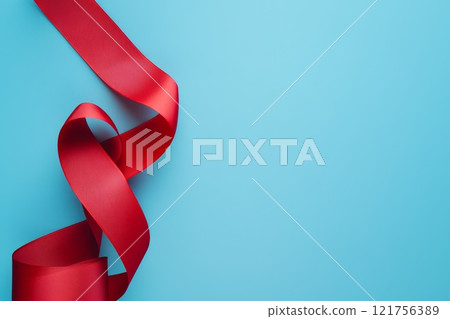 A red ribbon, isolated on blue background. 121756389