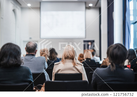 Speaker giving a talk in conference hall at business event. Rear view of unrecognizable people in audience at the conference hall. Business and entrepreneurship concept Speaker giving a talk in conference hall at business event. Rear view of unrecognizable people in audience at the conference hall. Business and entrepreneurship concept 121756732