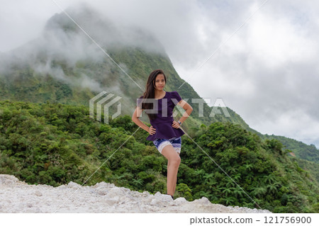 Portrait of a beautiful young Filipina woman against the backdrop of tropical mountains covered with clouds Portrait of a beautiful young Filipina woman against the backdrop of tropical mountains covered with clouds 121756900