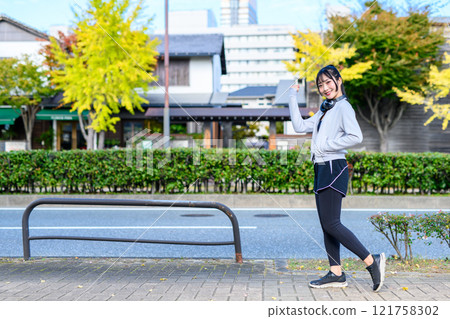A cool woman walking in a residential area outdoors Training Diet Exercise A cool woman walking in a residential area outdoors Training Diet Exercise 121758302