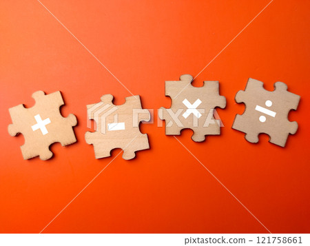 Wooden puzzle with math symbol on a orange background. Education concept. 121758661