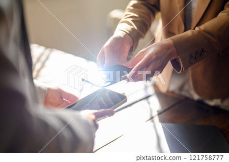 A scene where something is exchanged digitally 121758777