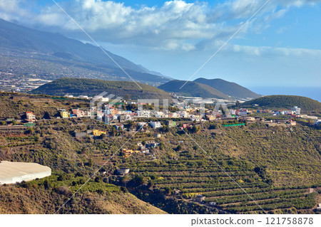 Above landscape view of growing banana plantation farm in Los Llanos, Spain with copy space. Scenic aerial of agriculture fields and hills. Farming fresh, nutritious vitamin fruit in a countryside 121758878