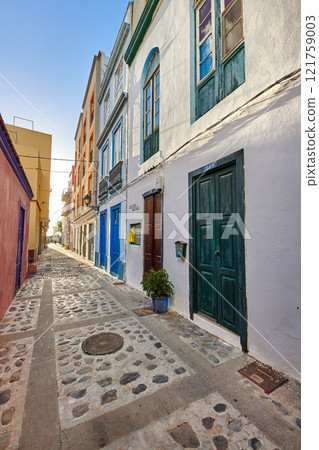 City view of residential houses or buildings in quiet alleyway street in Santa Cruz, La Palma, Spain. Historical spanish and colonial architecture in a tropical village and famous tourism destination City view of residential houses or buildings in quiet alleyway street in Santa Cruz, La Palma, Spain. Historical spanish and colonial architecture in a tropical village and famous tourism destination 121759003