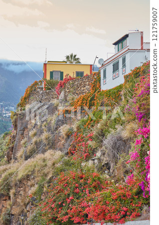 City view of residential buildings or houses on hill cliff in Santa Cruz, La Palma, Spain. Historical spanish, colonial architecture, vibrant flowers in tropical village of famous tourism destination City view of residential buildings or houses on hill cliff in Santa Cruz, La Palma, Spain. Historical spanish, colonial architecture, vibrant flowers in tropical village of famous tourism destination 121759007