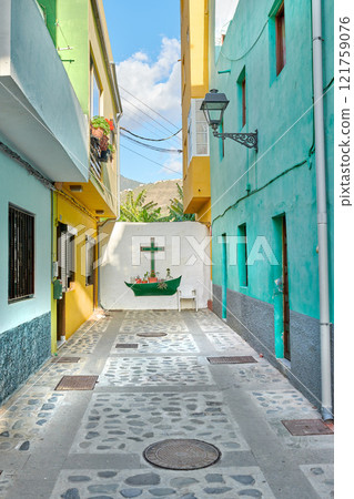 Colorful old buildings with a wall with a cross or crucifix in the city of Santa Cruz de La Palma. Bright and vibrant homes or houses built by traditional architecture in the morning in a village 121759076