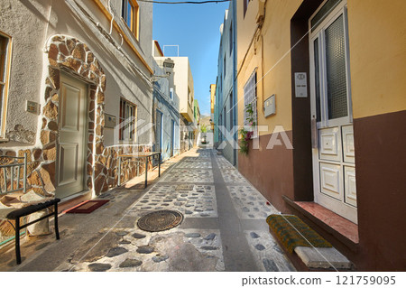 Scenic street view of old historic houses, residential buildings, traditional infrastructure in cobblestone alleyway road. Tourism abroad, overseas travel destination in Santa Cruz de La Palma, Spain Scenic street view of old historic houses, residential buildings, traditional infrastructure in cobblestone alleyway road. Tourism abroad, overseas travel destination in Santa Cruz de La Palma, Spain 121759095
