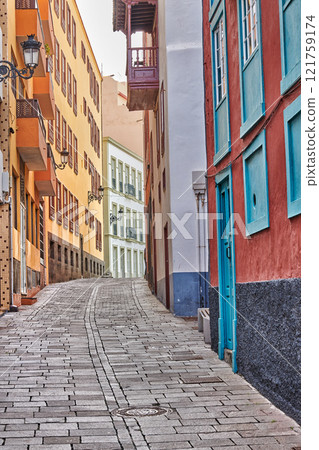 Narrow cobbled street or alley between colorful buildings in Santa Cruz, de La Palma. Bright and classical architecture in a small city or village. Beautiful houses or homes with a vintage design 121759174