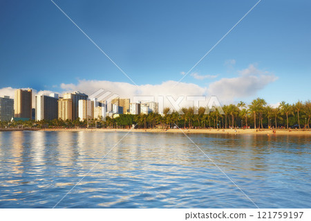 Beautiful landscape of a city near the beach and blue sky for a holiday or vacation destination. Cityscape surrounded by nature, trees, the sea, and the ocean. Scenic view of the urban scene by water 121759197