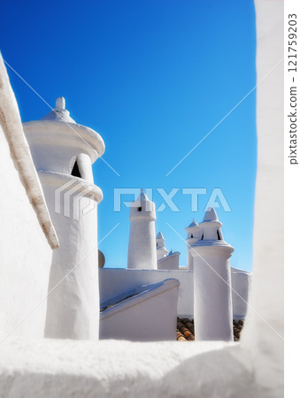 Historic ventilation chimney on a roof of a vintage building. Traditional architecture airing system in a village. Exterior view of a rural home or house rooftop isolated on a blue sky background Historic ventilation chimney on a roof of a vintage building. Traditional architecture airing system in a village. Exterior view of a rural home or house rooftop isolated on a blue sky background 121759203