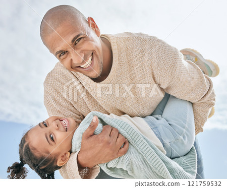 Portrait of cheerful Latino father from below carrying his cute little daughter while bonding together outdoors. Happy man and playful girl having fun while enjoying quality family time together 121759532
