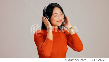 Woman, headphones and happy with music in studio with mockup space for streaming by background. Japanese person, girl and audio subscription for sound with eyes closed, smile and listening to track Woman, headphones and happy with music in studio with mockup space for streaming by background. Japanese person, girl and audio subscription for sound with eyes closed, smile and listening to track 121759776