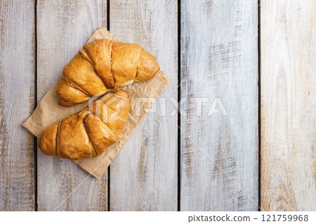 Coffee with croissants. Baked crispy croissant on a wooden board, breakfast. Homemade Croissant . Coffee with croissants. Baked crispy croissant on a wooden board, breakfast. Homemade Croissant . 121759968