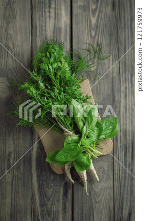 Green fresh parsley with roots and basil. Fresh herbs for salad. The concept of organic food. Ingredients for detox drink 121759973