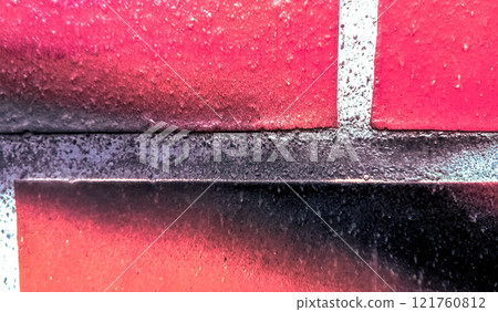 red brick wall with a black stain red brick wall with a black stain 121760812