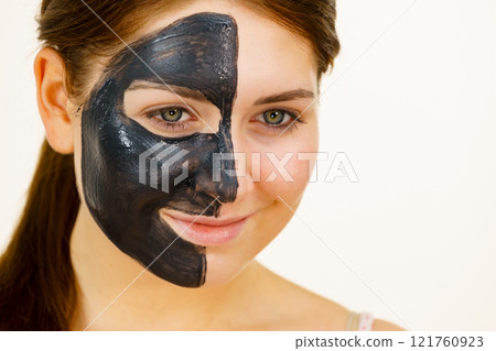 Woman with charcoal facial mask 121760923