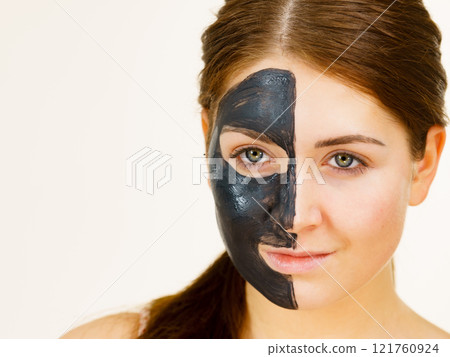 Woman with charcoal facial mask 121760924
