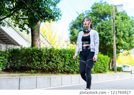 A cool woman walking in a residential area outdoors Training Diet Exercise A cool woman walking in a residential area outdoors Training Diet Exercise 121760927