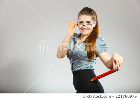 Teacher looking elegant woman holding big pencil Teacher looking elegant woman holding big pencil 121760979