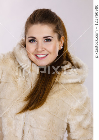 Happy attractive woman wearing furry coat 121760980