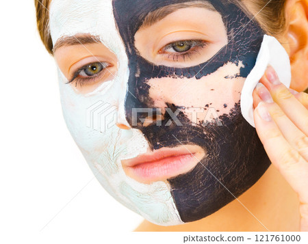 Girl remove black white mud mask from face 121761000