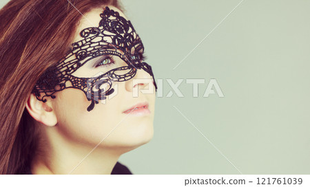 Mysterious woman wearing lace mask 121761039