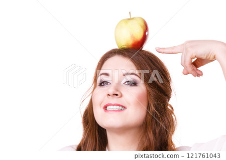 Woman funny girl holds on head apple fruit 121761043