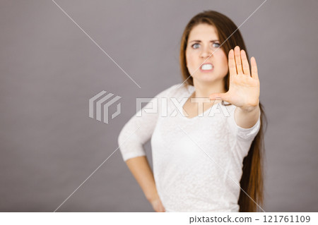 Angry apodicticity woman showing stop with hand Angry apodicticity woman showing stop with hand 121761109