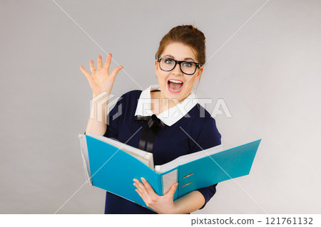Happy positive business woman holding binder with documents 121761132