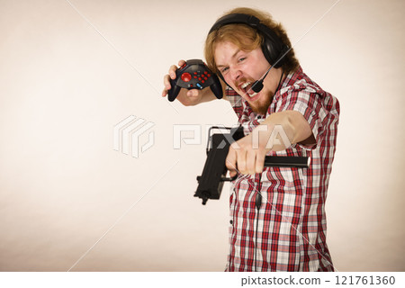 Gamer man shooting from gun Gamer man shooting from gun 121761360