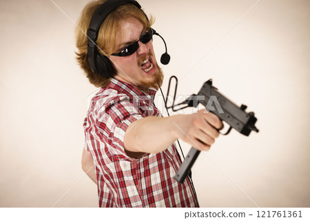 Gamer man shooting from gun Gamer man shooting from gun 121761361