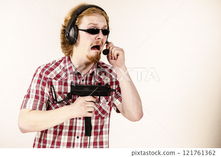 Gamer man shooting from gun Gamer man shooting from gun 121761362