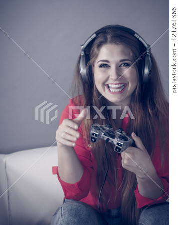 Young woman playing video games Young woman playing video games 121761366