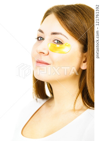 Woman with gold patches under eyes Woman with gold patches under eyes 121761392
