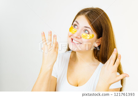 Woman with gold patches under eyes Woman with gold patches under eyes 121761393