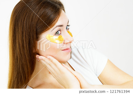 Woman with gold patches under eyes Woman with gold patches under eyes 121761394