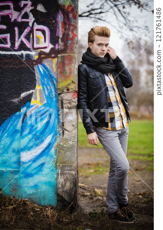 Fashion male portrait on graffiti wall Fashion male portrait on graffiti wall 121761486