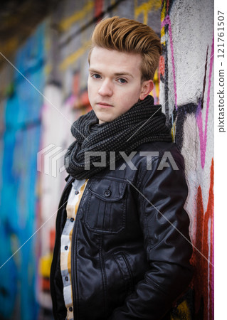 Fashion male portrait on graffiti wall Fashion male portrait on graffiti wall 121761507