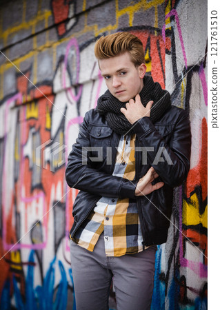 Fashion male portrait on graffiti wall Fashion male portrait on graffiti wall 121761510