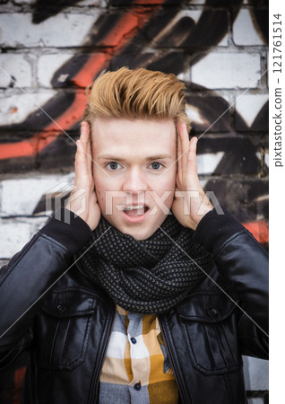 Surprised male face on graffiti wall Surprised male face on graffiti wall 121761514