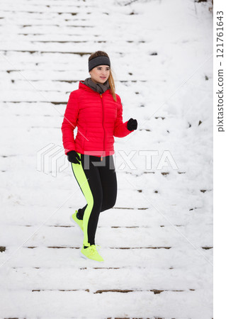 Woman wearing sportswear exercising during winter 121761643