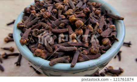 Macro Shot of Whole Dried Cloves in a Light Blue Bowl with Soft Blurred Background Macro Shot of Whole Dried Cloves in a Light Blue Bowl with Soft Blurred Background 121761874