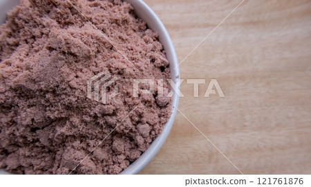 Close-Up Top View of Himalayan Black Salt Pakistani (Kala Namak) in a White Bowl on a Wooden Surface Close-Up Top View of Himalayan Black Salt Pakistani (Kala Namak) in a White Bowl on a Wooden Surface 121761876