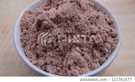 Kala Namak Himalayan Pakistani Black Salt in White Bowl Close Up View 121761877