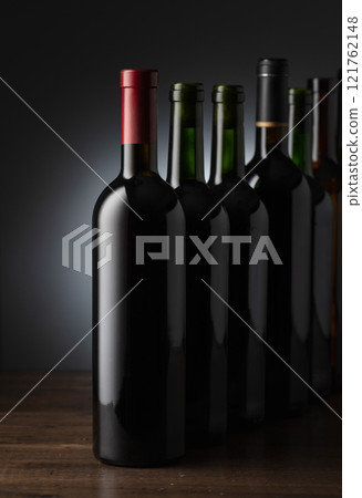 Bottles of wine on a old wooden table. Bottles of wine on a old wooden table. 121762148