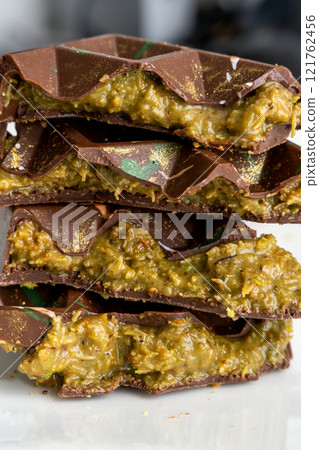 Dubai chocolate bar with pistachio paste, tahini and kataifi dough. Confectionery and sweets. 121762456