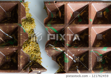 Dubai chocolate bar with pistachio paste, tahini and kataifi dough. Confectionery and sweets. 121762459