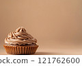 Side view of cupcake with creamy mousse on top, mocha or chocolate mousse dessert with smooth texture, soft brown background. Color trend concept, color of the year 2025. Banner with copy space. 121762600